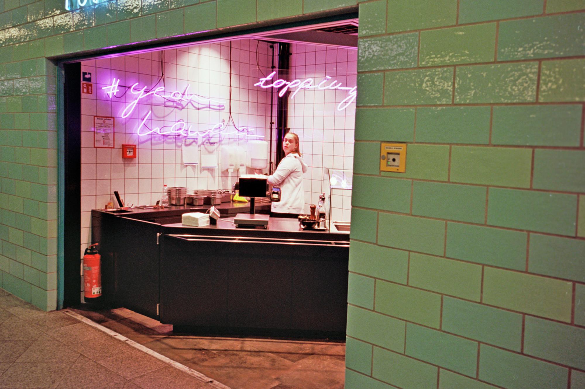 Exterior of a small modern kitchen with neon sign