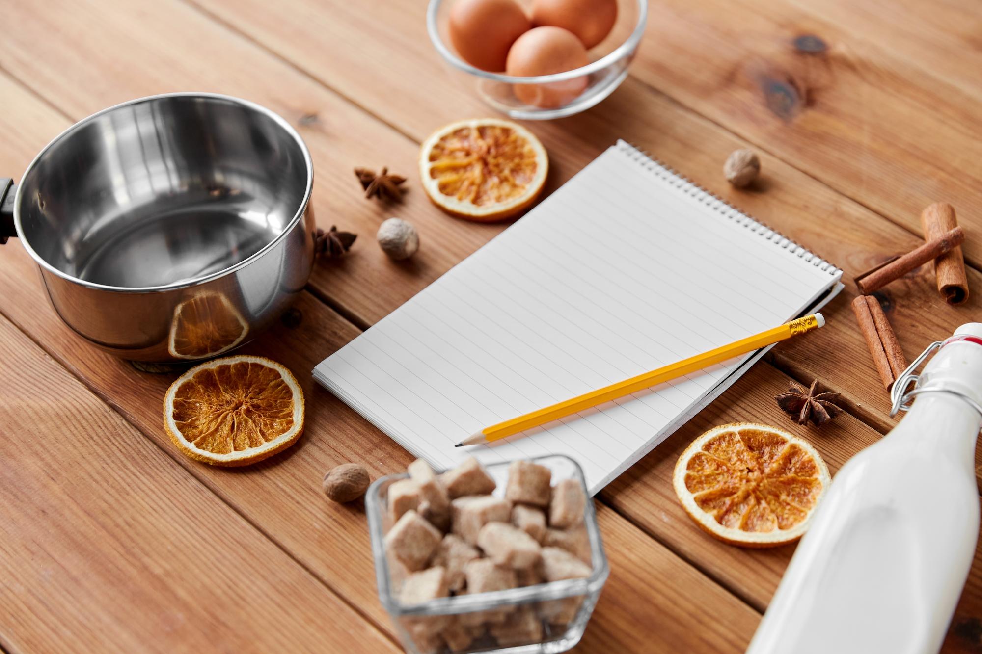 Notebook with recipe notes and measured spoons